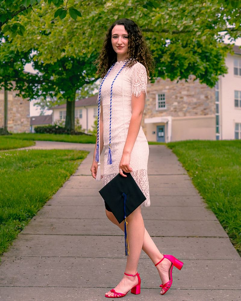 Senior portrait of Liora in a white dress on campus, graduation photography by Campbell Shepard, Frederick, MD