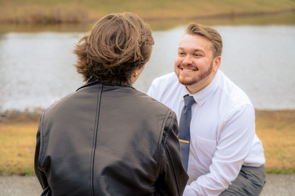 Candid moment between a couple by the water, man in a tie, couples photography by Campbell Shepard, Frederick, MD